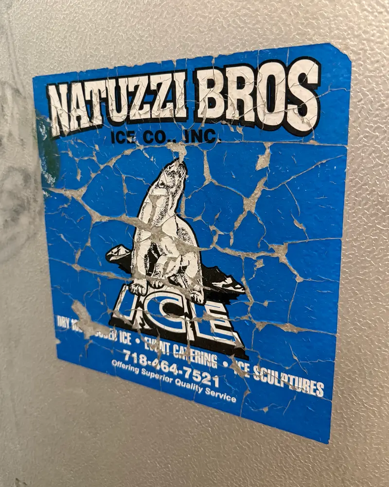 Cracked vintage Natuzzi Bros. Ice Co. sticker with a polar bear and a 718 phone number